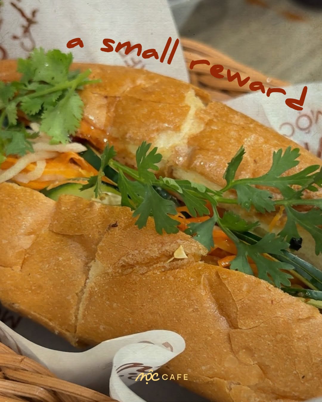 Bánh Mì close-up with fresh herbs at MỘC Cafe