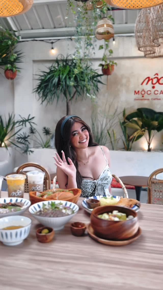Guests enjoying a full Vietnamese meal spread at MỘC Cafe