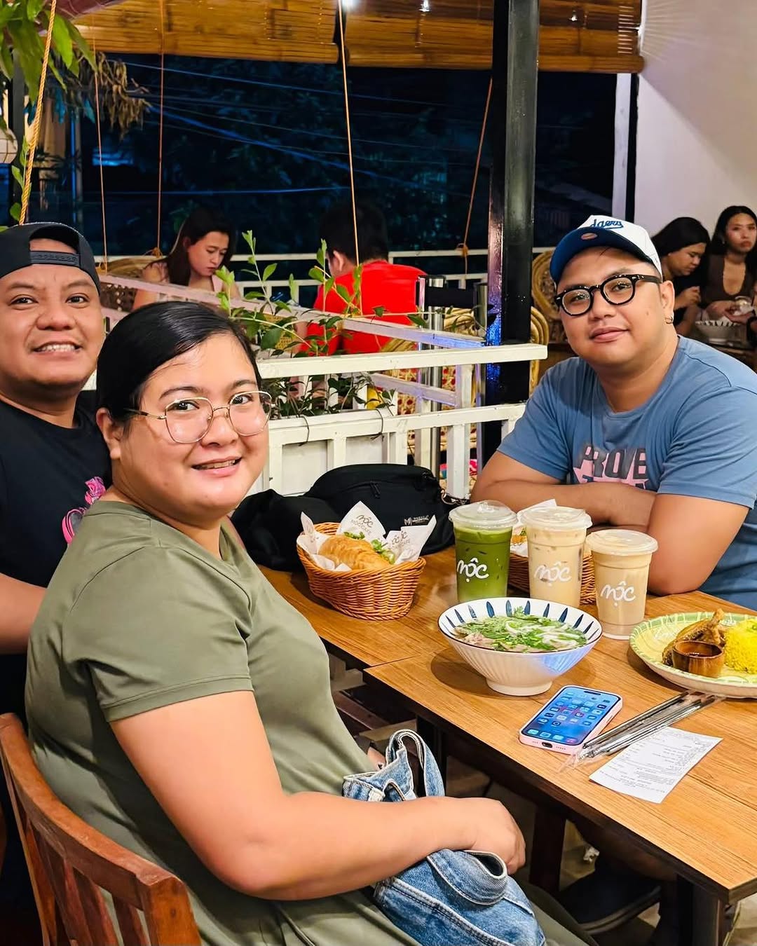 Group of friends at MỘC Cafe dining at night